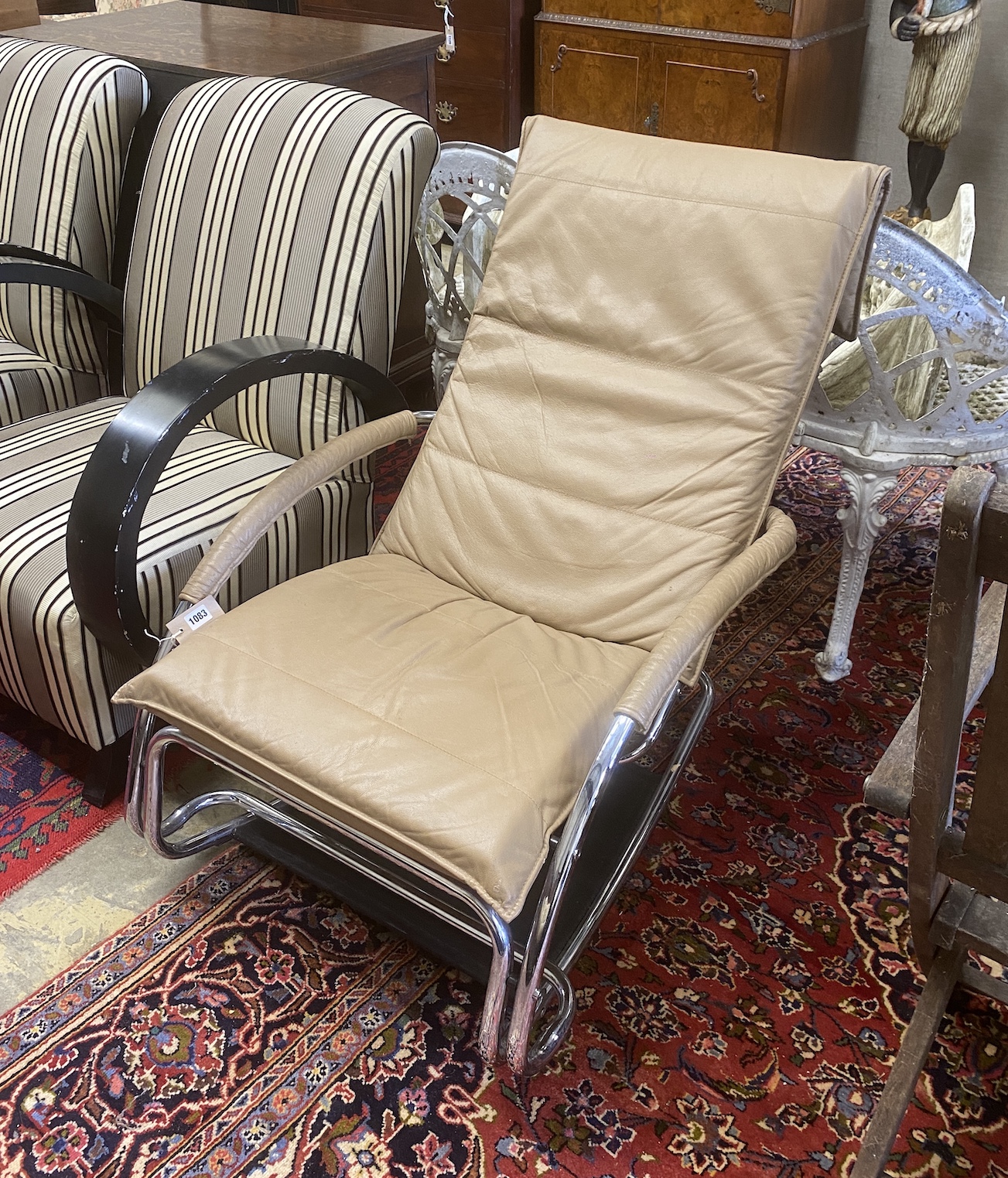 A contemporary brown leather and chrome rocking chair, width 67cm, depth 82cm, height 90cm